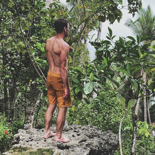 A man standing in a jungle.