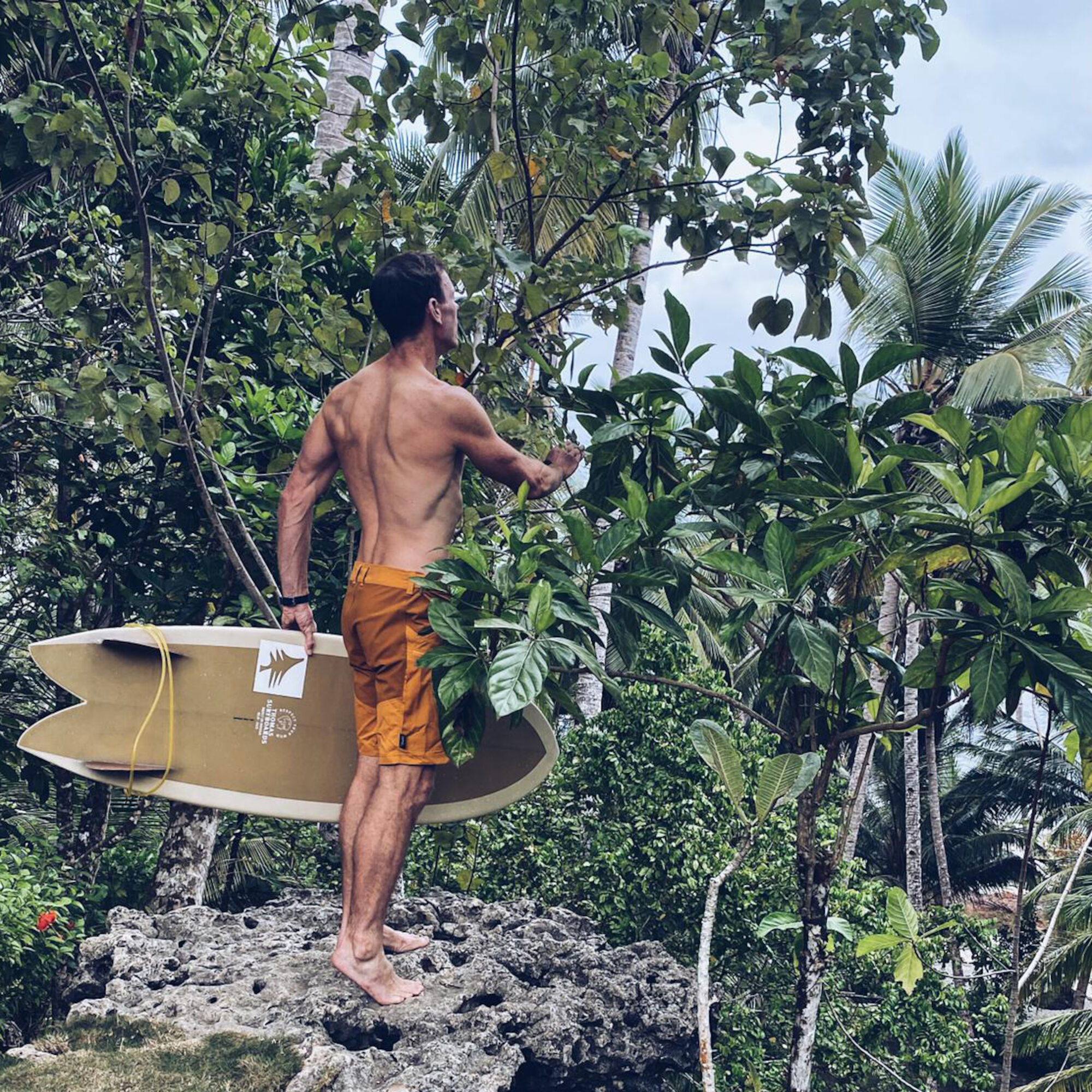 A man carrying a surfboard.