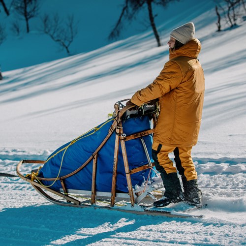 A person pulling a sled.