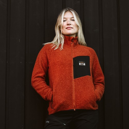 A woman wearing a red sweater.