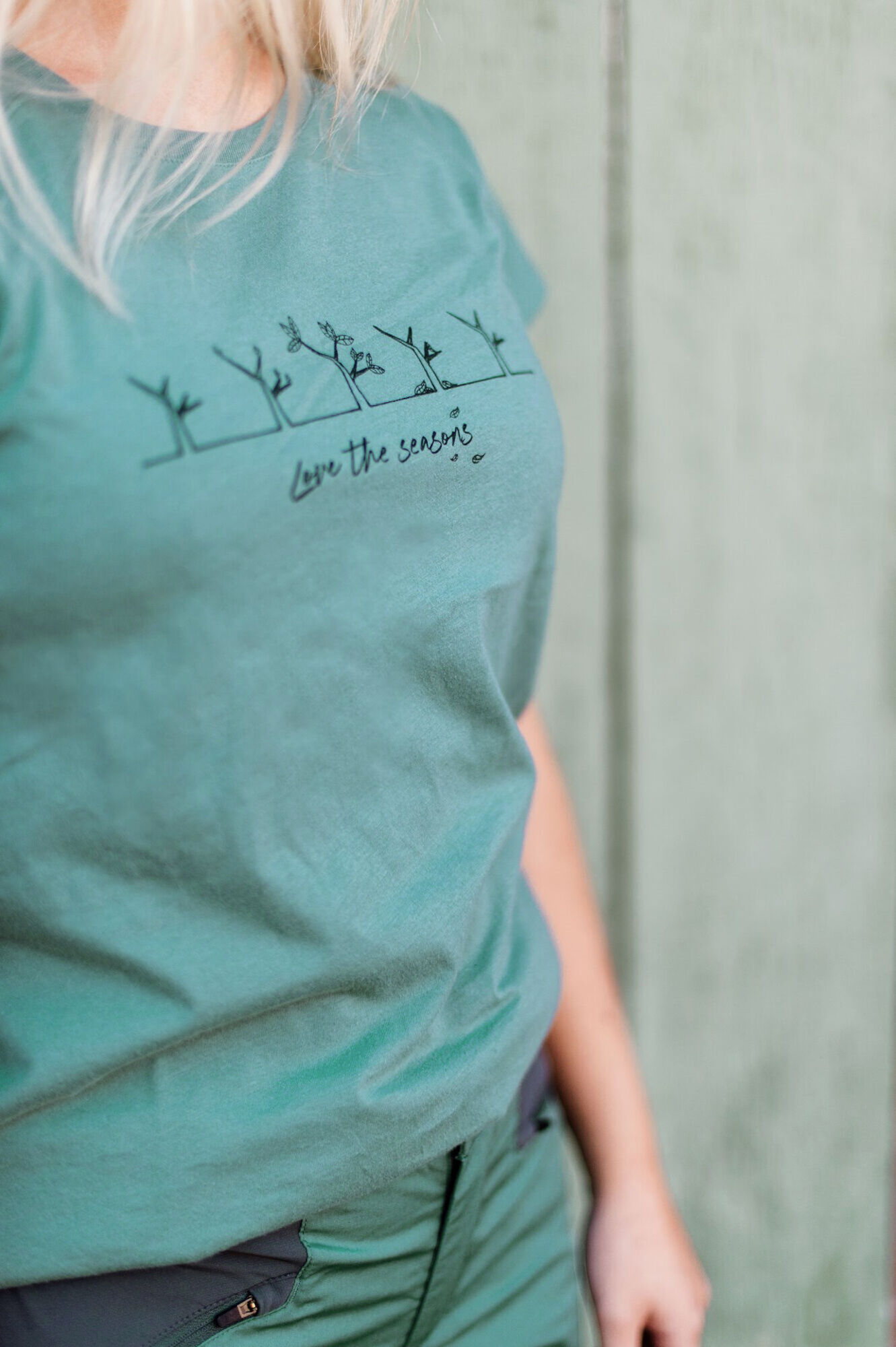 A woman wearing a t-shirt with writing on it.