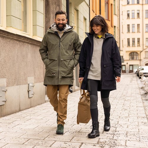 A man and woman walking down a street.