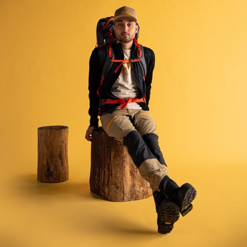A man sitting on a stump.