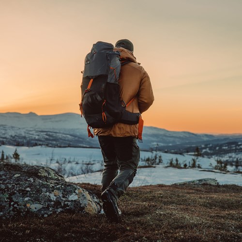 A man with a backpack on a mountain.